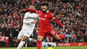 Liverpool's Egyptian striker #11 Mohamed Salah scores his team fourth goal during the English League Cup quarter-final football match between Liverpool and West Ham United at Anfield in Liverpool, north west England on December 20, 2023. (Photo by Oli SCARFF / AFP) / RESTRICTED TO EDITORIAL USE. No use with unauthorized audio, video, data, fixture lists, club/league logos or 'live' services. Online in-match use limited to 120 images. An additional 40 images may be used in extra time. No video emulation. Social media in-match use limited to 120 images. An additional 40 images may be used in extra time. No use in betting publications, games or single club/league/player publications. /