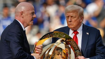 EAST RUTHERFORD, NEW JERSEY - JULY 13: U.S. President Donald Trump and FIFA President Gianni Infantino carry the FIFA Club World Cup trophy on stage before presenting it to Chelsea FC at MetLife Stadium on July 13, 2025 in East Rutherford, New Jersey. This is the first time the U.S. has hosted the the FIFA CWC competition, one year before the U.S., Mexico and Canada are scheduled to host the World Cup in 2026. Chip Somodevilla/Getty Images/AFP (Photo by CHIP SOMODEVILLA / GETTY IMAGES NORTH AMERICA / Getty Images via AFP)