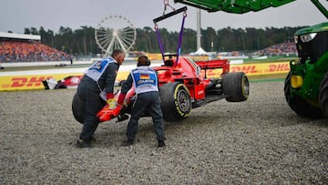 A tractor lifts the car of Ferrari's German driver Sebastian Vettel during the German Formula One Grand Prix at the Hockenheim racing circuit on July 22, 2018 in Hockenheim, southern Germany. / AFP PHOTO / Andrej ISAKOVIC