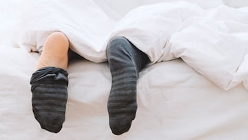 man feet taking socks off
