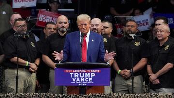 FILE PHOTO: Republican presidential nominee and former U.S. President Donald Trump speaks as members of National Border Patrol Council stand next to him during a campaign rally in Prescott Valley, Arizona, U.S., October 13, 2024. REUTERS/Go Nakamura/File Photo
