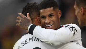 Manchester United's English striker Marcus Rashford celebrates with Manchester United's Brazilian midfielder Casemiro (L) before having his 'second goal' disallowed for handball after a VAR (Video Assistant Referee) review during the English Premier League football match between Wolverhampton Wanderers and Manchester United at the Molineux stadium in Wolverhampton, central England on December 31, 2022. (Photo by Adrian DENNIS / AFP) / RESTRICTED TO EDITORIAL USE. No use with unauthorized audio, video, data, fixture lists, club/league logos or 'live' services. Online in-match use limited to 120 images. An additional 40 images may be used in extra time. No video emulation. Social media in-match use limited to 120 images. An additional 40 images may be used in extra time. No use in betting publications, games or single club/league/player publications. /