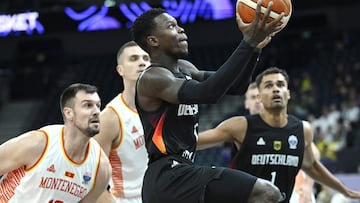 Germany's Dennis Schroder (C) and Montenegro's Zoran Nikolic (L) vie during the FIBA EuroBasket 2025 Group B basketball match between Montenegro and Germany in Tampere, Finland, on August 27, 2025.