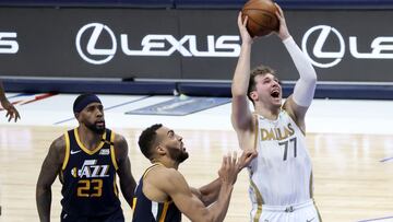 Apr 5, 2021; Dallas, Texas, USA; Dallas Mavericks guard Luka Doncic (77) shoots past Utah Jazz center Rudy Gobert (27) during the third quarter at American Airlines Center. Mandatory Credit: Kevin Jairaj-USA TODAY Sports