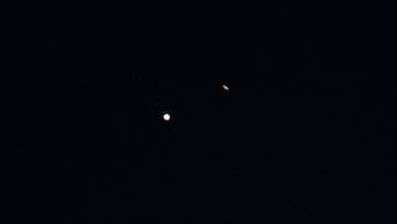 Jupiter (L) and Saturn (R) are seen during the "Great Conjunction" where the two planets appear a tenth of a degree apart from one another, in this handout photo near Chapel Hill, North Carolina, U.S. December 21, 2020. NASA/Bill Ingalls/Handout via REUTERS THIS IMAGE HAS BEEN SUPPLIED BY A THIRD PARTY. MANDATORY CREDIT