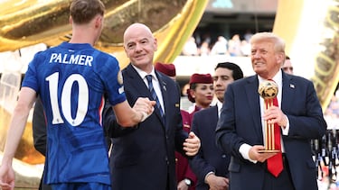 U.S. President Donald Trump holds the golden ball trophy as Chelsea's Cole Palmer greets FIFA president Gianni Infantino after Chelsea won against Paris St Germain in the FIFA Club World Cup final, at the MetLife Stadium in East Rutherford, New Jersey, U.S., July 13, 2025. REUTERS/Kevin Lamarque/Pool