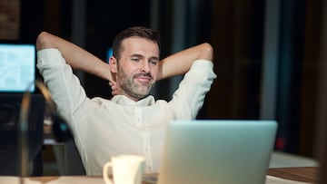 Satisfied man resting in his office