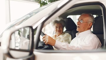 Old couple in a car salon. Family buying the car. Elegant woman with her husband. Senior by a car.