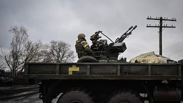 An Ukrainian soldier keeps position sitting on a ZU-23-2 anti-aircraft gun at a frontline, northeast of Kyiv on March 3, 2022. - A Ukrainian negotiator headed for ceasefire talks with Russia said on March 3, 2022, that his objective was securing humanitarian corridors, as Russian troops advance one week into their invasion of the Ukraine. (Photo by Aris Messinis / AFP)