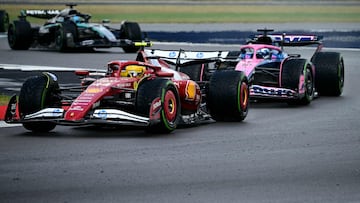 Ferrari's British driver Lewis Hamilton overtakes Alpine's French driver Pierre Gasly during the Formula One British Grand Prix at the Silverstone motor racing circuit in Silverstone, central England, on July 6, 2025. (Photo by Ben STANSALL / AFP)