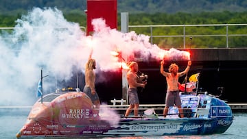 Three Scottish brothers (L-R) Lachlan, Jamie and Ewan MacLean celebrate as they arrive on their boat into Cairns in northern Queensland on August 30, 2025. The three Scottish brothers stepped ashore in Australia on August 30 after claiming a new record for rowing non-stop and unsupported across the Pacific Ocean, "over the moon" to be back on dry land. They set off in a carbon fibre dinghy from Lima in Peru in April for the 9,000 miles (14,500 kilometres) journey, enduring violent storms and sickness during their 139 days at sea. (Photo by Brian CASSEY / AFP)