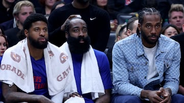 LOS ANGELES, CALIFORNIA - APRIL 12: (L-R) Paul George #13, James Harden #1 and Kawhi Leonard #2 of the LA Clippers watch play from the bench during a 110-109 loss to the Utah Jazz at Crypto.com Arena on April 12, 2024 in Los Angeles, California. User is consenting to the terms and conditions of the Getty Images License Agreement. Harry How/Getty Images/AFP (Photo by Harry How / GETTY IMAGES NORTH AMERICA / Getty Images via AFP)