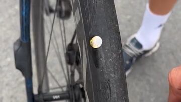 Calmejane muestra chinchetas clavadas en la rueda de su bicicleta.