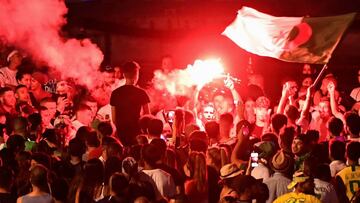 TOPSHOT - Algeria supporters celebrate after Algeria won the 2019 Africa Cup of Nations (CAN) semi-final football match against Nigeria, at the old harbour (vieux port) in Marseille, southern France, on July 14, 2019. - Riyad Mahrez rifled in a stoppage-t
