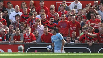 MANCHESTER, ENGLAND - SEPTEMBER 20: Carlos Tevez of Manchester City is abused by Manchester United fans during the Barclays Premier League match between Manchester United and Manchester City at Old Trafford on September 20 2009, in Manchester, England. (Photo by Tom Purslow/Manchester United via Getty Images)