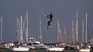 Ausralia acaba de entrar en la estación invernal y un frente frío golpea partes del sur del país. Sin embargo, eso no es impedimento para realizar determinados deportes acuáticos, más propios del verano. En la imagen, un hombre practica kitesurf junto a varias embarcaciones en un nublado y tormentoso día en la bahía de Port Phillip, en Melbourne.