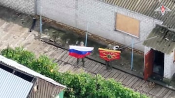 A still image, taken from footage released by the Russian Defence Ministry, shows what it said to be Russian soldiers displaying flags, following the capture of Ukraine's settlement of Zaporizke in the Dnipropetrovsk region, in the course of Russia-Ukraine military conflict, in this image from video released August 25, 2025. Russian Defence Ministry/Handout via REUTERS ATTENTION EDITORS - THIS IMAGE HAS BEEN SUPPLIED BY A THIRD PARTY. NO RESALES. NO ARCHIVES. MANDATORY CREDIT. BEST QUALITY AVAILABLE. LOGO FROM SOURCE. Verification lines: - Reuters was able to independently verify the location with the position of the buildings, the roads and terrain layout that matched the file and satellite imagery of the area.
