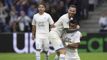 Marseille's Dimitri Payet, right, Marseille's Dario Benedetto, Marseille's Maxime Lopez celebrate after Lille's Gabriel scored an own goal during the French League One soccer match between Marseille and Lille at the Velodrome stadium i