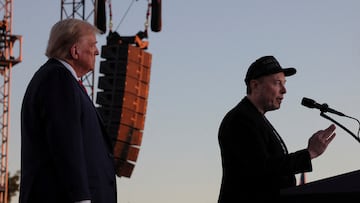 FILE PHOTO: Tesla CEO and X owner Elon Musk speaks next to Republican presidential nominee and former U.S. president Donald Trump during a campaign rally, at the site of the July assassination attempt against Trump, in Butler, Pennsylvania, U.S., October 5, 2024. REUTERS/Brian Snyder/File Photo