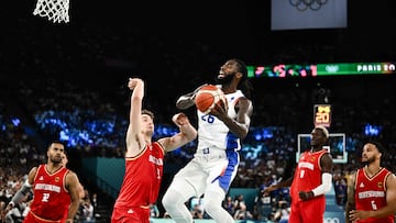 France's #26 Mathias Lessort goes to the basket past Germany's #09 Franz Wagner (L) in the men's semifinal basketball match between France and Germany during the Paris 2024 Olympic Games at the Bercy Arena in Paris on August 8, 2024. (Photo by Aris MESSINIS / AFP)