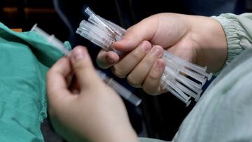 A medical personnel holds syringes containing Moderna vaccines against Covid-19 coronavirus at Taipei Tzu Chi Hospital in New Taipei City on June 9, 2021. (Photo by Sam Yeh / AFP)