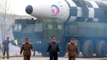 This picture taken on March 24, 2022 and released from North Korea's official Korean Central News Agency (KCNA) on March 25, 2022 shows North Korean leader Kim Jong Un (C) walking near what state media report says a new type inter-continental ballistic missile (ICBM), Hwasongpho-17 of North Korea's strategic forces before its test launch in an undisclosed location in North Korea. (Photo by various sources / AFP) / South Korea OUT / ---EDITORS NOTE--- RESTRICTED TO EDITORIAL USE - MANDATORY CREDIT "AFP PHOTO/KCNA VIA KNS" - NO MARKETING NO ADVERTISING CAMPAIGNS - DISTRIBUTED AS A SERVICE TO CLIENTS / THIS PICTURE WAS MADE AVAILABLE BY A THIRD PARTY. AFP CAN NOT INDEPENDENTLY VERIFY THE AUTHENTICITY, LOCATION, DATE AND CONTENT OF THIS IMAGE --- /