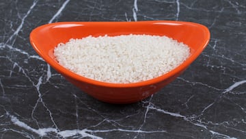 Healthy food. Raw rice in orange bowl . High quality photo