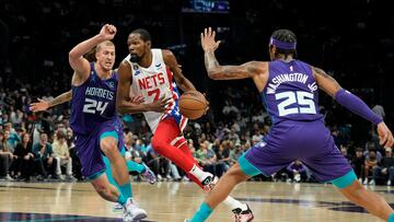 Nov 5, 2022; Charlotte, North Carolina, USA; Brooklyn Nets forward Kevin Durant (7) drives between Charlotte Hornets center Mason Plumlee (24) and forward P.J. Washington (25) during the first quarter at Spectrum Center. Mandatory Credit: Jim Dedmon-USA TODAY Sports