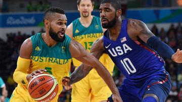 Australia's guard Patty Mills (L) tries to pass USA's guard Kyrie Irving during a Men's round Group A basketball match between Australia and USA at the Carioca Arena 1 in Rio de Janeiro on August 10, 2016 during the Rio 2016 Olympic Games. / AFP PHOTO / Andrej ISAKOVIC