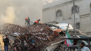 Members of the civil defence stand near a damaged site after what Syrian and Iranian media described as an Israeli air strike on Iran's consulate in the Syrian capital Damascus April 1, 2024. REUTERS/Firas Makdesi
