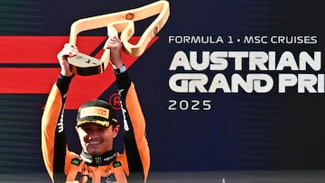 Winner McLaren's British driver Lando Norris celebrates on the podium with his trophy after the Formula One Austrian Grand Prix at the Red Bull Ring race track in Spielberg, Austria, on June 29, 2025. (Photo by Joe Klamar / AFP)