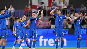 Slovenia's defender #13 Erik Janza, Slovenia's defender #06 Jaka Bijol and teammates celebrate qualifying for the knock-out stages on the pitch after the UEFA Euro 2024 Group C football match between England and Slovenia at the Cologne Stadium in Cologne on June 25, 2024. (Photo by Kirill KUDRYAVTSEV / AFP)