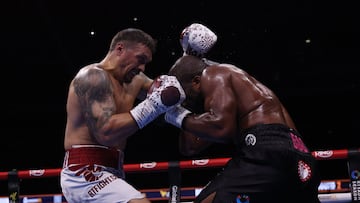 Ukraine's Oleksandr Usyk (L) and Britain's Daniel Dubois fight during their undisputed world heavyweight boxing title bout at Wembley Stadium in London on July 19, 2025. (Photo by Adrian Dennis / AFP)