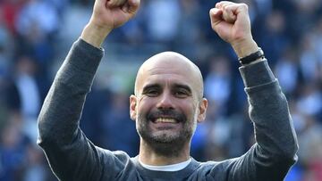 BRIGHTON, ENGLAND - MAY 12: Manchester City manager Pep Guardiola celebrates winning the Premier League title at full time after the Premier League match between Brighton & Hove Albion and Manchester City at American Express Community Stadium on May