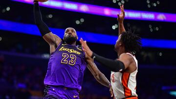 Dec 23, 2024; Los Angeles, California, USA; Los Angeles Lakers forward LeBron James (23) dunks for the basket against Detroit Pistons guard Jaden Ivey (23) during the second half at Crypto.com Arena. Mandatory Credit: Gary A. Vasquez-Imagn Images