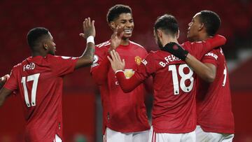 Manchester United's Bruno Fernandes, 2nd right, celebrates his side's sixth goal from a penalty kick with team mates during an English Premier League soccer match between Manchester United and Leeds United at the Old Trafford stadium in Manchest