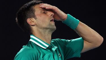 (FILES) This file photo taken on February 16, 2021 shows Serbia's Novak Djokovic reacting after losing a point against Germany's Alexander Zverev during their men's singles quarter-final match on day nine of the Australian Open tennis tournament in Melbou