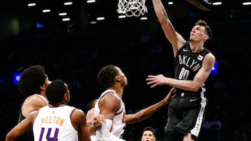 Dec 23, 2018; Brooklyn, NY, USA; Brooklyn Nets forward Rodions Kurucs (00) dunks against Phoenix Suns forward Richaun Holmes (21) in the fourth quarter at Barclays Center. Mandatory Credit: Nicole Sweet-USA TODAY Sports