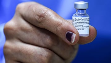 A nurse holds a used vial of Pfizer-BioNTech COVID-19 coronavirus vaccine at a vaccination centre in the Kindi Hospital in Iraq's capital Baghdad on April 14, 2021. (Photo by AHMAD AL-RUBAYE / AFP)