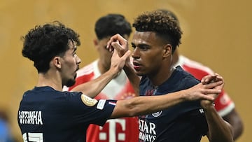 Paris Saint-Germain's French midfielder #14 Desire Doue (R) celebrates with teammate Portuguese midfielder #17 Vitinha (L) after scoring his team's first goal during the FIFA Club World Cup 2025 quarterfinal football match between France's Paris Saint-Germain and Germany's Bayern Munich at the Mercedes-Benz Stadium in Atlanta on July 5, 2025. (Photo by Paul ELLIS / AFP)