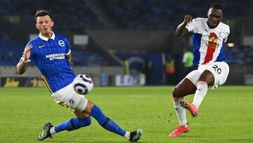 Crystal Palace's Zaire-born Belgian striker Christian Benteke (R) shoots but fails to score during the English Premier League football match between Brighton and Hove Albion and Crystal Palace at the American Express Community Stadium in Brighton, so