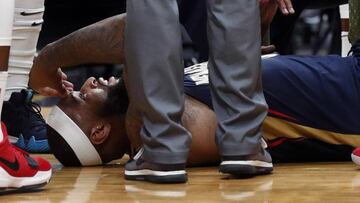 FILE - In this Jan. 26, 2018, file photo, then-New Orleans Pelicans center DeMarcus Cousins lies on the court while being tended to after an injury during the second half of an NBA basketball game against the Houston Rockets in New Orleans. A person with