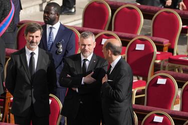 El presidente de Eslovaquia, Peter Pellegrini (centro), y el ministro de Asuntos Exteriores, Juraj Blanar (izquierda), se sientan frente a sus asientos antes del funeral del papa Francisco en la Plaza de San Pedro del Vaticano.