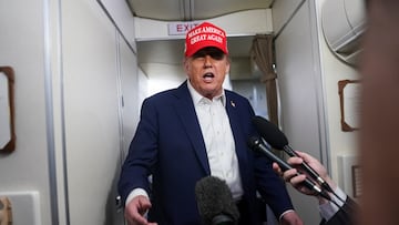 U.S. President Donald Trump speaks to members of the media on board Air Force One on the way to New Jersey, U.S., July 4, 2025. REUTERS/Nathan Howard
