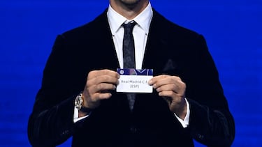 AC Milan's Swedish senior advisor Zlatan Ibrahimovic holds up the slip of Real Madrid during the draw ceremony for the group stage of the 2025-2026 UEFA Champions League football tournament, at the Grimaldi Forum in Monaco on August 28, 2025. (Photo by Frederic DIDES / AFP)