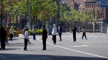 Residents stand on a street waiting for nucleic acid test during lockdown amid the coronavirus disease (COVID-19) pandemic, in Shanghai, China, April 17, 2022. REUTERS/Aly Song