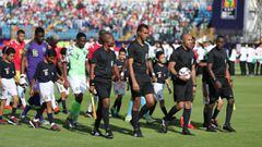 Soccer Football - Africa Cup of Nations 2019 - Group B - Nigeria v Guinea - Alexandria Stadium, Alexandria, Egypt - June 26, 2019  The referee and match officials lead out the teams before the match  REUTERS/Suhaib Salem