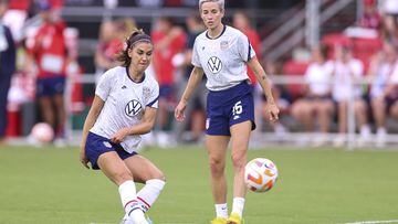WASHINGTON, DC - SEPTEMBER 06: Alex Morgan #13 (L) and Megan Rapinoe #15 of the United States warm up before playing against Nigeria at Audi Field on September 06, 2022 in Washington, DC.   Tim Nwachukwu/Getty Images/AFP