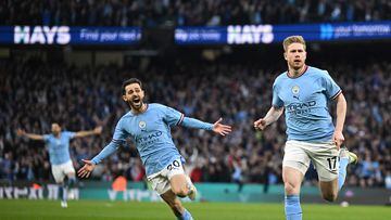 Manchester City's Belgian midfielder Kevin De Bruyne (R) celebrates scoring the opening goal during the English Premier League football match between Manchester City and Arsenal at the Etihad Stadium in Manchester, north west England, on April 26, 2023.