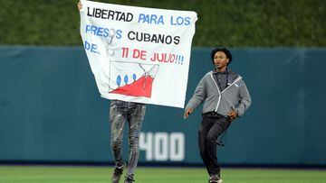 The man waved a banner demanding freedom for political prisoners in Cuba. He was immediately tackled by security and removed from the loanDepot Park stadium